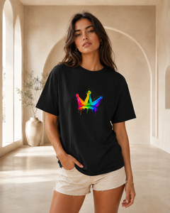 Woman wearing a black t-shirt with a colorful butterfly design in a bright room.