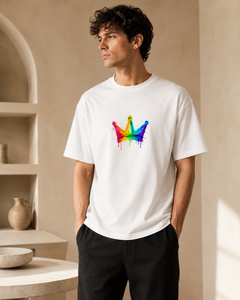 Man wearing a white t-shirt with a colorful graphic design in a neutral setting