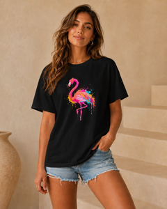 Woman wearing a black t-shirt with a colorful flamingo design in an indoor setting.