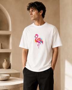 Man wearing a white t-shirt with a colorful flamingo design in a neutral setting.
