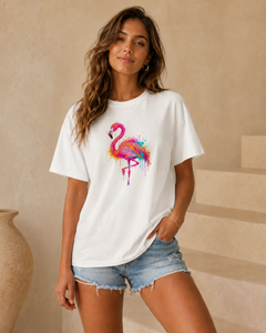 Woman wearing a white t-shirt with a colorful flamingo design in a casual setting.