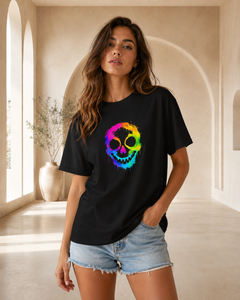 Woman wearing a black t-shirt with a colorful skull design in a bright room.