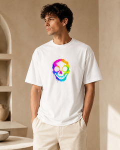 Man wearing a white t-shirt with a colorful skull design in a neutral setting