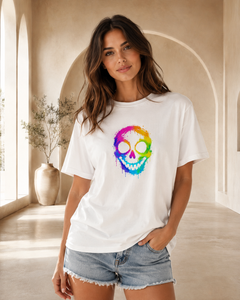 Woman wearing a white t-shirt with a colorful skull design in a bright room.