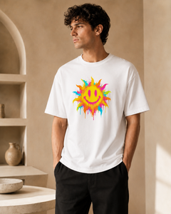 Man wearing a white t-shirt with a colorful sun design in a neutral setting