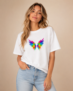 Woman wearing a white t-shirt with a colorful angel wing design on a beige background